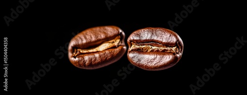 Coffee Beans Flying in the Air With a Light Brown Background Creating a Capti...