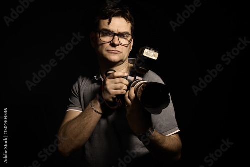 Photographer man in glasses and shirt with camera isolated