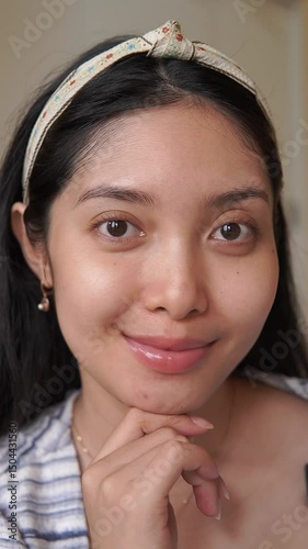 Close up shot of a young Asian woman with bare face before applying make up, healthy skin.