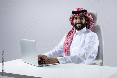 A collection of images of Arab business professionals, both male and female, in traditional clothing working together in a modern office setting, using laptops, discussing projects, and collaborating 