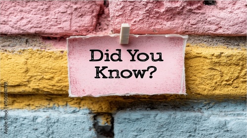 Interesting fact displayed on wall featuring brickwork paper and clothespin and question photo