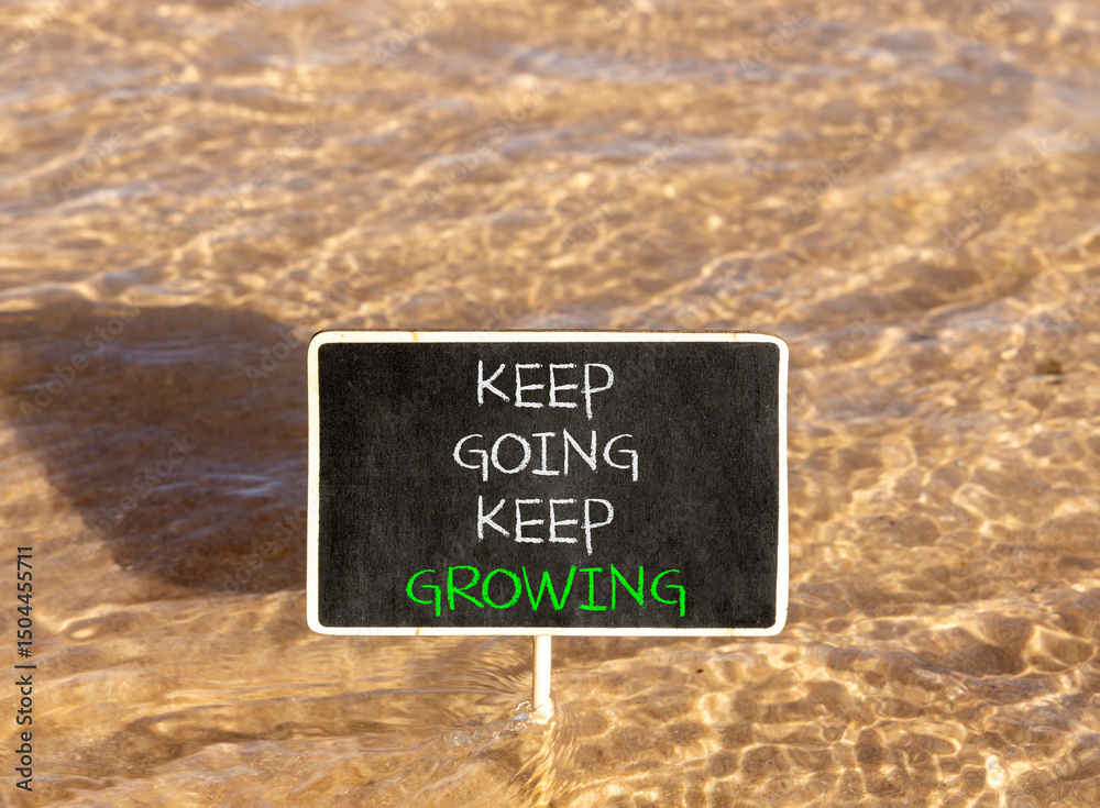 Naklejka premium Keep going and growing symbol. Concept words phrase Keep going keep growing on beautiful black blackboard. Beautiful Red sea water background. Business Keep going and growing concept. Copy space.