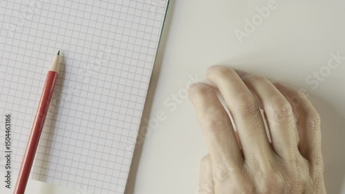 Woman's hand anxiously taps work desk