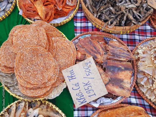 A variety of Vietnamese dried fish with a sign for 