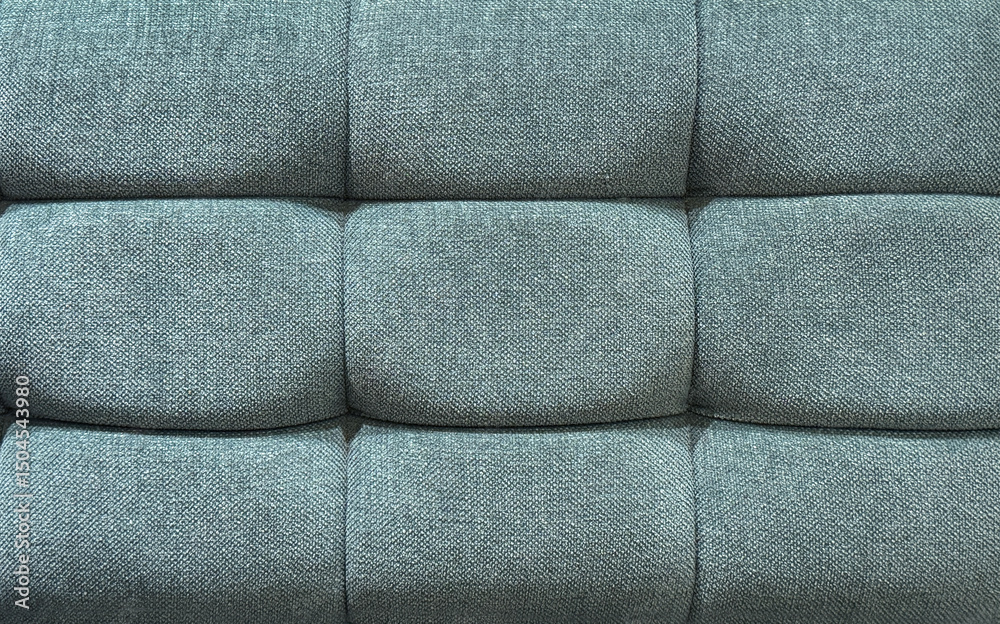 Fototapeta premium Close up of blue fabric upholstered panel with cushion and padded wall. Suitable for sofa backing, upholstery, and other soft seating. Seamless background texture.