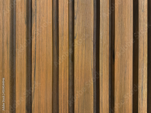 Close up of natural wood fluted panel or striped panel, seamless background texture.