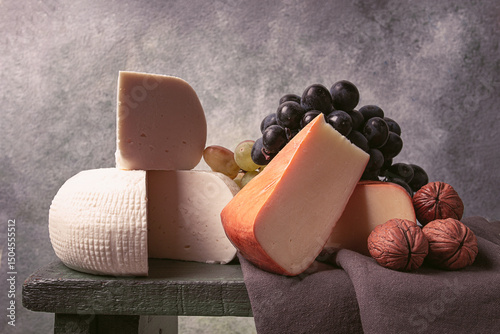 Georgian cheese, Imeretian and smoked suluguni, grapes, nuts, on a cutting board, Georgian cuisine, no people, photo