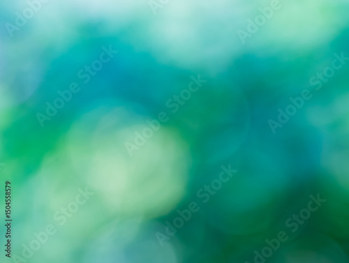 Dreamy blue green zen blurred background of various soft circles of confusion of blues and greens for any creative project. Create a lovely ethereal, serene and tranquil backdrop from nature's colors.