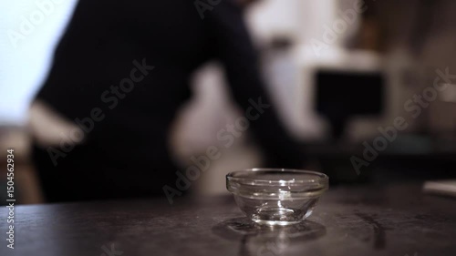Pouring Golden Honey from Spoon into Glass Bowl Close-Up