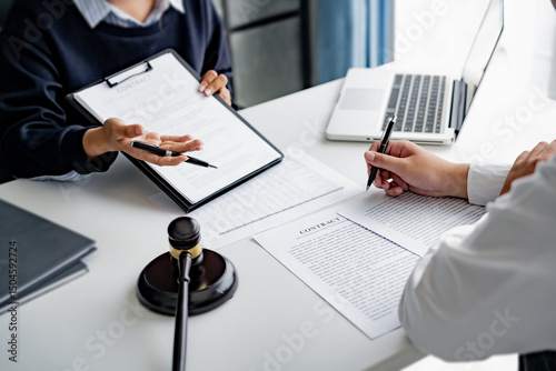 serious courtroom lawyer preparing litigation documents for business client before official hearing