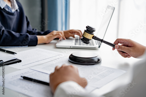 professional lawyer consulting with client about legal contract inside law firm meeting room