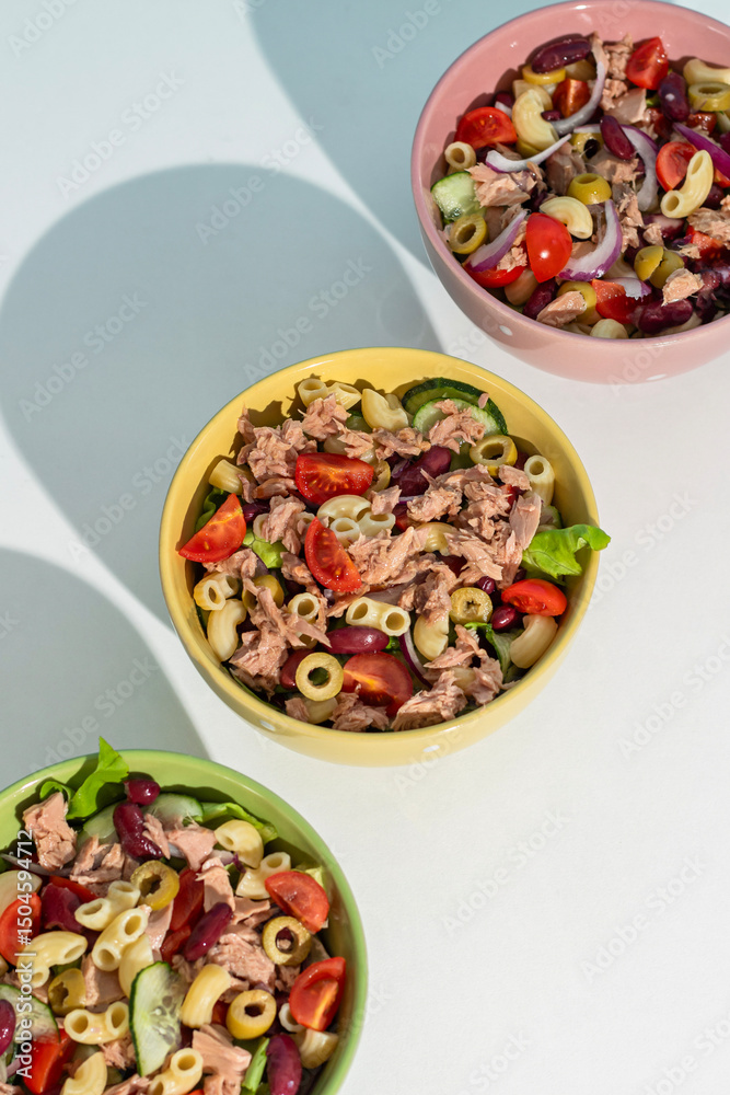 Balanced diet - Healthy tuna salads mixed with macaroni, lettuce, cheery tomato, peas and beans cucumber on white background. Balanced diet - Healthy tuna salads mixed with macaroni, lettuce, cheery tomato, peas and beans cucumber on white background.