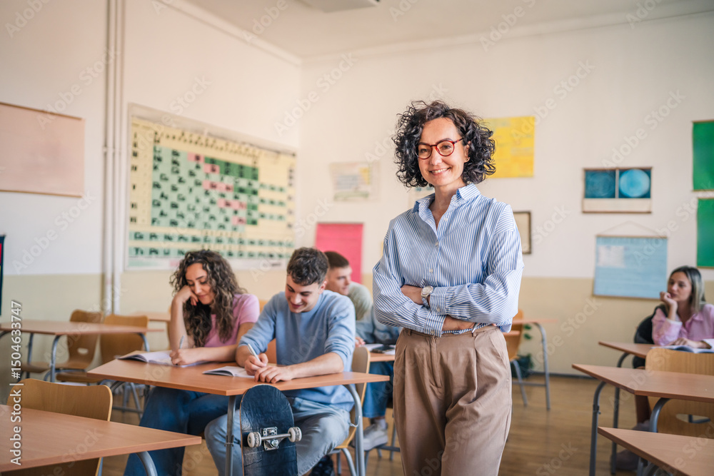 Obraz premium A mature female teacher stand confidently in her elementary classroom