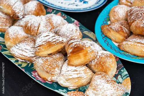 Fototapeta Naklejka Na Ścianę i Meble -  Many sfogliatella cakes on street market. Sfogliatelle puff pastry, naples bakery