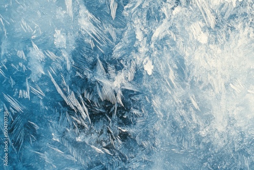 Frozen patterns create an intricate icy landscape, displaying a wintery texture with crystallized details and ethereal, cool-toned beauty.