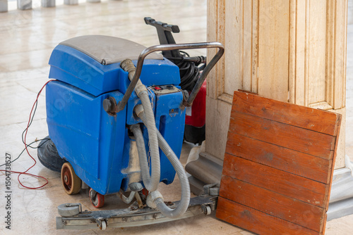 Blue floor scrubber, Used floor cleaner on the stone floor, Large machine