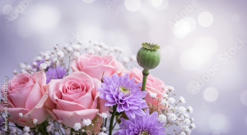 Delicate floral arrangement featuring pink roses, lavender chrysanthemums and baby's breath
