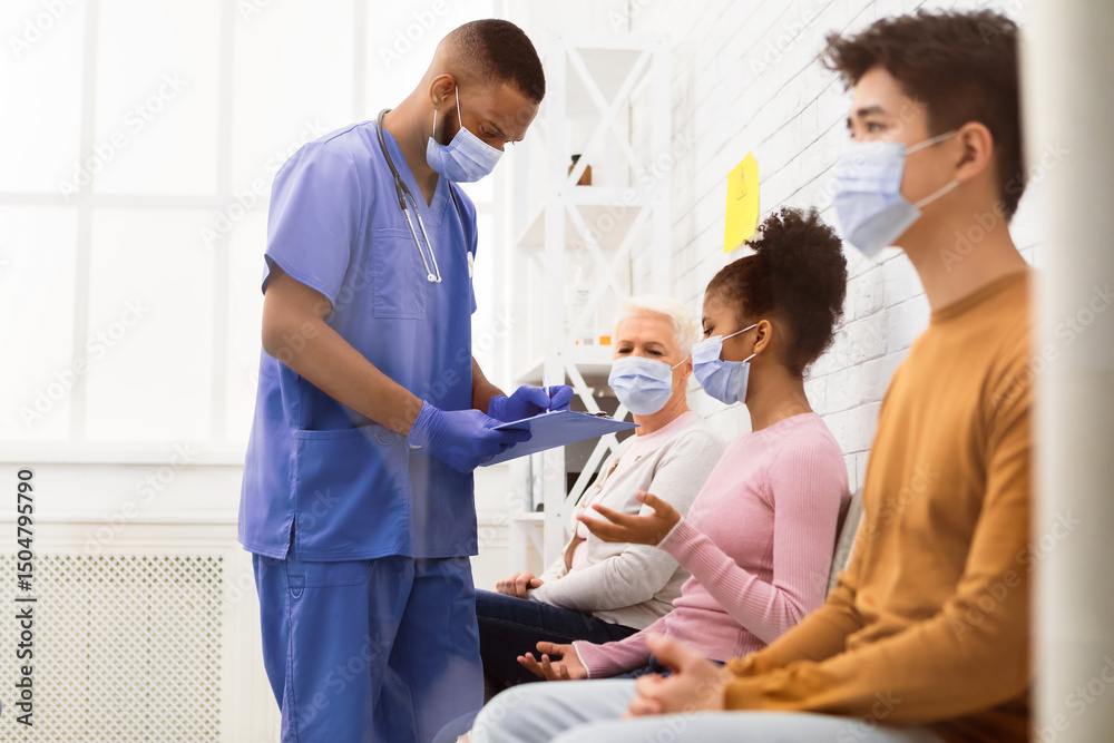 Obraz premium African Male Nurse Working Talking With Multiracial Patients In Hospital During Coronavirus Covid-19 Vaccination. Vaccine For Corona Virus, Covid Immunization Campaign Concept
