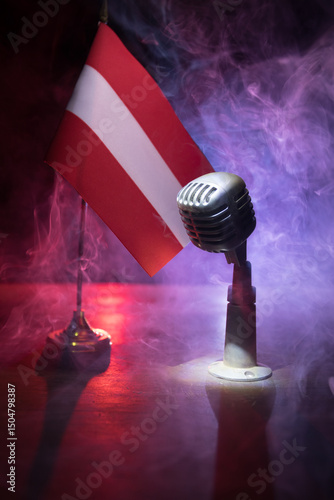 Canvas Print Microphone on a background of a blurry flag of Austria close-up