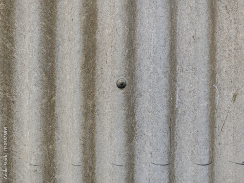 Detailed texture of aged corrugated surface, presenting a weathered and industrial aesthetic. The rough, patterned material shows signs of aging for realistic backdrop and design projects.