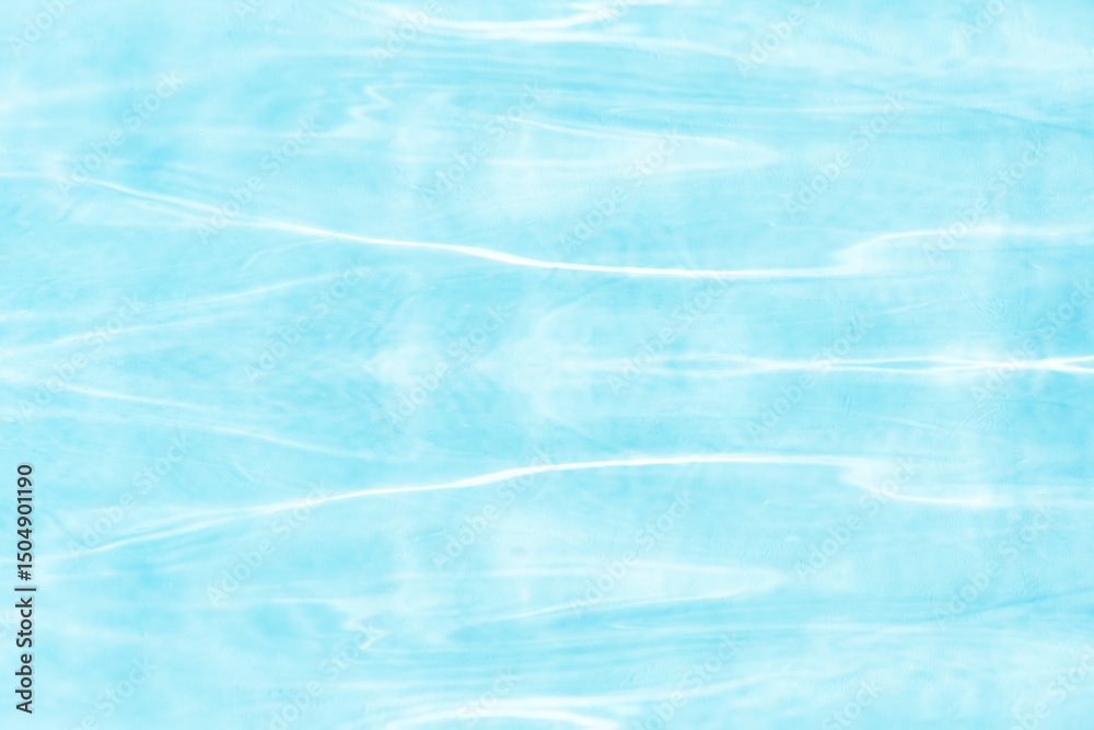 Fototapeta premium Blue water with ripples on the surface. Defocus blurred transparent blue colored clear calm water surface texture with splashes and bubbles. Water waves with shining pattern texture background.