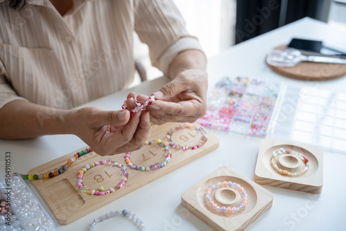 Senior mature older asian woman Art hobby handmade making beads jewellery accessories handcraft hobby