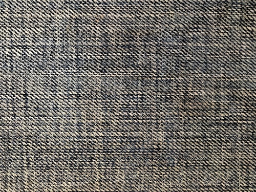 Close-up texture of faded blue and white denim fabric.
