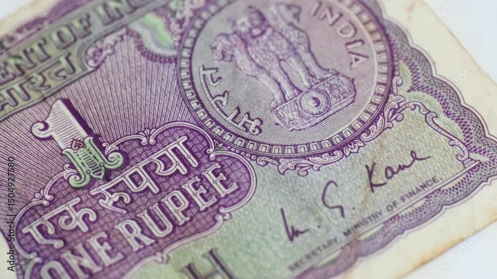 Indian old one rupee note with Finance Secretary M.G.KAUL signature and national Emblem. internal shot, push in shot, 4k.