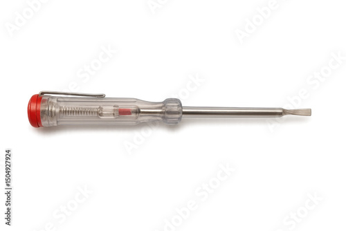 Electrical testing screwdriver resting horizontally, revealing voltage detection against transparent surface photo