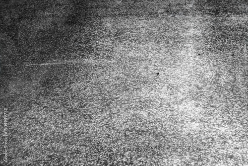 Monochromatic backdrop showcasing a granulated texture with dark and light contrasts, offering a versatile surface for creative projects and designs, bringing an industrial aesthetic. photo