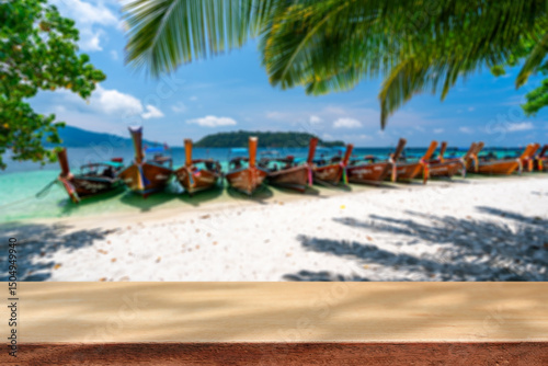 Fototapeta Naklejka Na Ścianę i Meble -  Wooden table with tropical beautiful white sand beach and blue sky background, Summer vacation concept and copy space