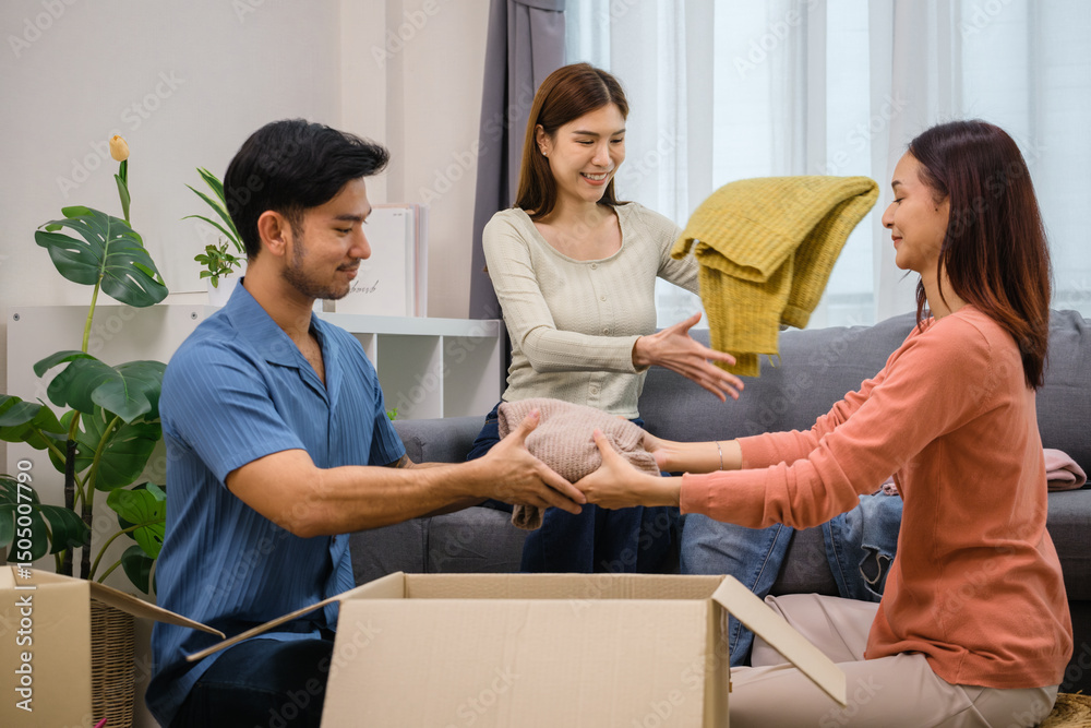 Obraz premium group of friend sorting and packing clothes into a donation box.community support, and charitable giving
