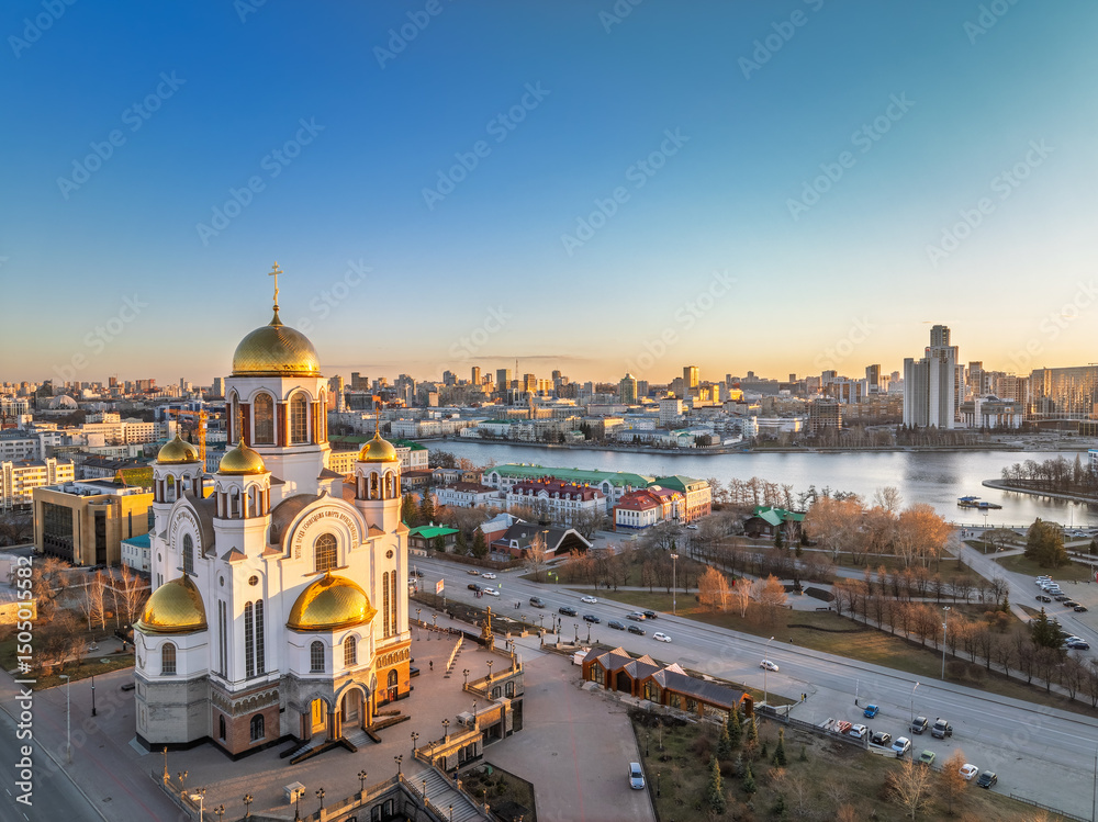 Fototapeta premium Early spring or autumn Yekaterinburg and Temple on Blood in clear sunset. Aerial view of Yekaterinburg, Russia. Translation of the text on the temple: Honest to the Lord is the death of His saints.