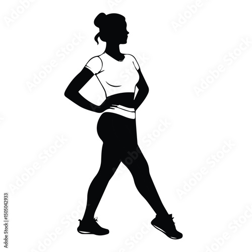 Female fitness model in activewear, posing in profile view. Silhouette of a woman with hands on hips, walking, in a studio setting.