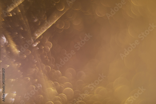 Abstract Golden Bokeh Background with Soft Light and Circles for Festive or Dreamy Atmosphere