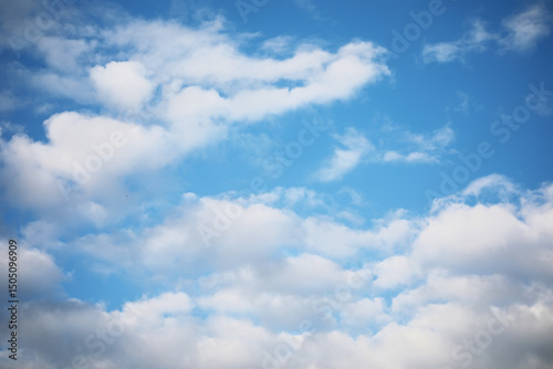 Serene Blue Sky with Fluffy White Clouds on a Clear Sunny Day