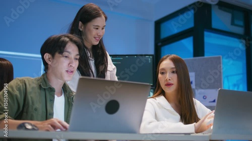 Asian AI Programmers, Software developer Team Reviewing Machine Learning Code and Editing Prompt for Ai Chatbot Development Reviewing Code and Diagrams Together working together in Office Workspace.