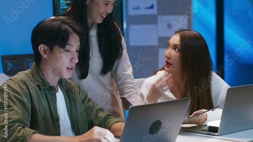 Asian team of software developer, software engineers working together, analyzing code on laptop, testing ai software, troubleshooting, Researching, discussing on computer screen in office workplace.
