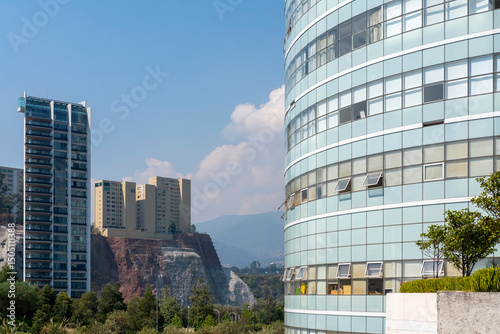 Modern architecture in Santa Fe, Mexico City with curved glass facade and high-rise buildings, showcasing innovation, business, and corporate development themes.