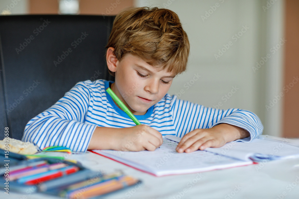 Portrait of cute healthy happy school kid boy at home making homework. Little child writing with colorful pencils, indoors. Elementary school and education. Kid learning writing letters and numbers Portrait of cute healthy happy school kid boy at home making homework. Little child writing with colorful pencils, indoors. Elementary school and education. Kid learning writing letters and numbers