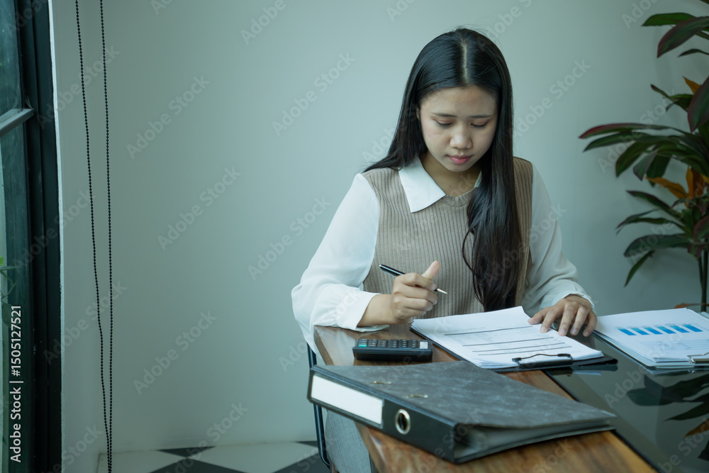 Naklejka premium Asian businesswoman working alone in office