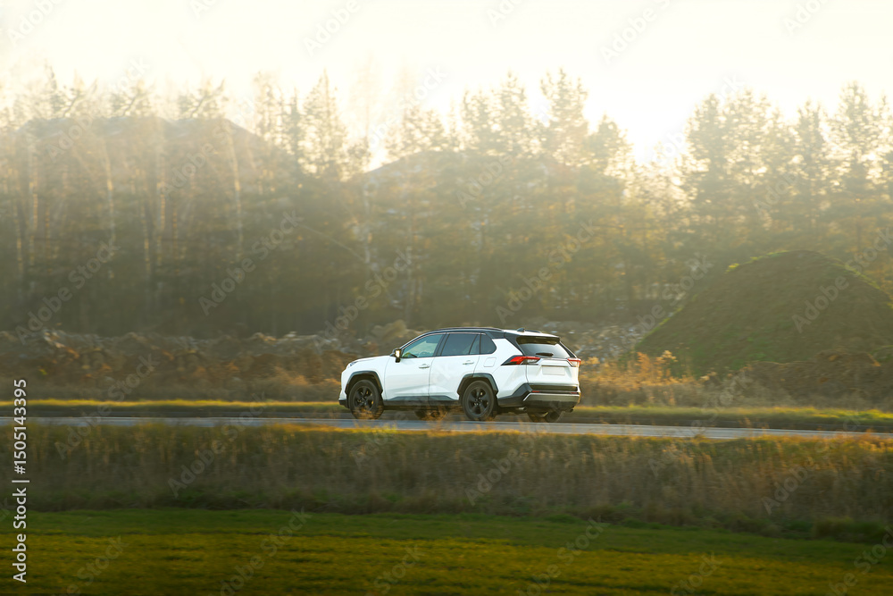 Fototapeta premium SUV driving on a sunny country road