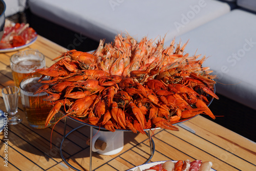 Seafood platter overflowing with prawns on a wooden table photo