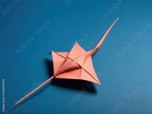  Delicate Origami Stingray Gracefully Poised Against a Reef Blue Background
