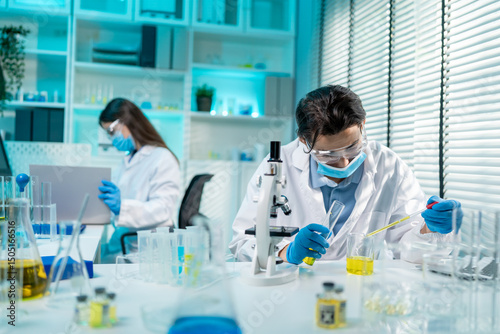 Asian male and female scientis work together in the research laboratory.  photo