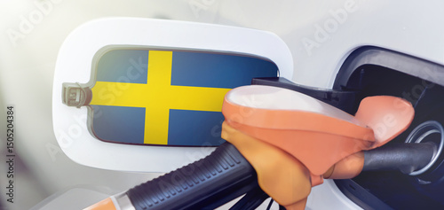The Sweden flag on the lid of the gas tank of a car at a gas station in close-up. High or low gasoline prices at Swedish gas stations. Gasoline prices are rising due to a shortage of diesel fuel