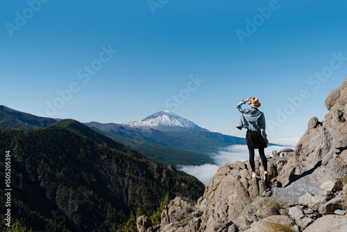 Tableau sur toile Tourist standing on mountain admiring breathtaking view of volcano Teide, Tenerife, Canary, Spain