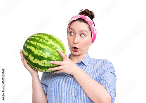Surprised young woman holding a big watermelon, looking amazed. Studio portrait, humorous expression, isolated on transparent background PNG.