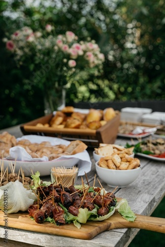 Photography Outdoor table with appetizers in a garden setting.