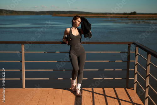 Running concept. Sporty girl running outdoors along river bank. panorama. healthy lifestyle